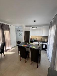 a kitchen with a table and chairs in a room at Panorama Apartment in Kavála