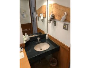 a bathroom with a sink and a mirror at Business Hotel Crescent - Vacation STAY 49938v in Tokyo +3 photos