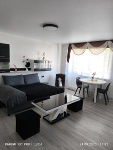 a living room with a couch and a table at Atpūta pie Gora in Rēzekne
