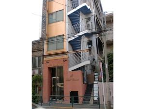 a building with stairs on the side of it at Business Hotel Crescent - Vacation STAY 49929v in Tokyo +4 photos