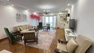 a living room with a couch and a table at Vintage Charm & Spacious Comfort in Zayed 2000 - only families & single travelers in Sheikh Zayed +35 photos