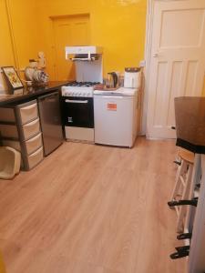 una cocina con estufa y refrigerador en Central location, en Staines upon Thames 1 foto más