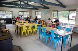 a restaurant with tables and chairs with people sitting at them at Glentanner Park Centre in Glentanner