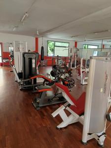 a gym with several treadmills and cardio machines at AiRPORT ALEXANDER in Genoa +8 photos