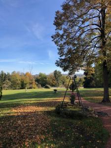 a statue in a park next to a tree at 2 bedroom Gîte-Cottage- Chateau de Charmeil in Charmeil