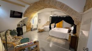 a bedroom with a bed and a room with a bathroom at SFPH Caeser - AKKO in Acre