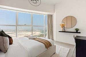 a bedroom with a bed and a large window at Silkhaus Premier 2BR Apartment in Marina Bay in Mushayrib