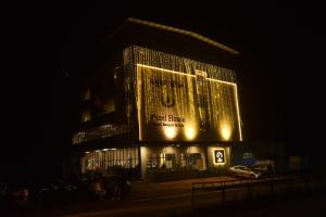 a building with a lit up sign on it at night at Hotel Pixel House in Hubli