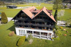 an aerial view of a large house on a green field at Apart-Garni Innerwiesn in Mayrhofen