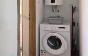 a washing machine with a bowl on top of it at 1 Bedroom Cozy Apartment In Karlobag in Karlobag