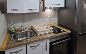 a kitchen counter top with a sink and a sink at 1 Bedroom Cozy Apartment In Karlobag in Karlobag