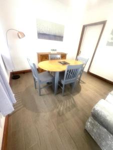 a dining room table and chairs in a room at Blossom Cottage in Strensall