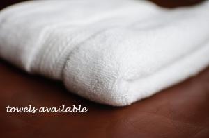 a close up of a white towel on a bed at Acheninver Hostel in Achiltibuie