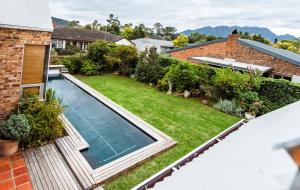 an aerial view of a backyard with a swimming pool at Protea Garden Cottage in Stellenbosch