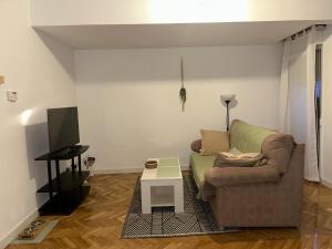a living room with a couch and a table at Piso Torreón de los Guzmanes in Avila