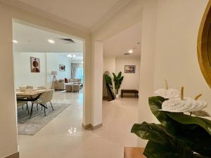 a living room with a table and a dining room at Waterfront Modern loft overlooking downtown 3BR in Sharjah +20 photos
