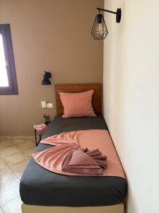 a bedroom with a bed with a pink blanket on it at Tropical Issara Sal in Santa Maria +31 photos