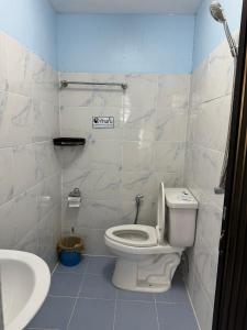 a bathroom with a toilet and a sink at Riverside Hostel Phuket in Phuket Town