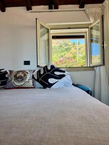 a bedroom with a large bed with a window at View Terrace Apartment in Taormina - Murmuria Eolia in Taormina