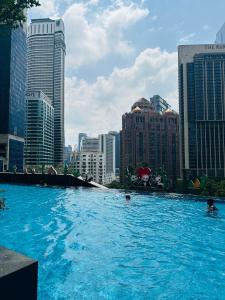 a swimming pool in a city with tall buildings at KLcc suites astra 8 kia peng in Kuala Lumpur