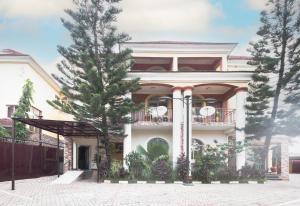 a house with a tree in front of it at ROYALE CROWN VILLA in Abuja