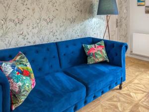 a blue couch with two pillows on it in a living room at The Room Next Door in Flemingston