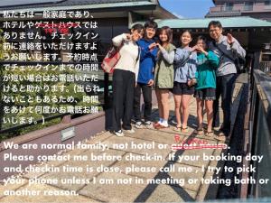 a group of people standing in front of a sign at Strawberry Villa - Vacation STAY 16883 in Ichihara