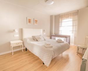 a white bedroom with a bed and a window at Preciosa casa para familias y grupos en Navarra in Añorbe +15 photos