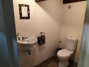 a bathroom with a toilet and a sink at Suites on 74 in Worcester +26 photos