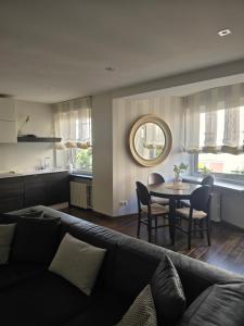 a living room with a couch and a table at Downtown Boulevard View Residence in Šiauliai