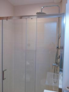 a shower with a glass door in a bathroom at la pomme d'amour in Sully-sur-Loire