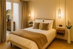a bedroom with a large white bed with pillows at La Suite Parisienne in Paris