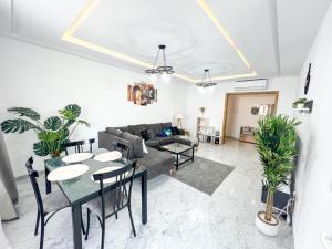 a living room with a couch and a table at Amazing 2BR Apartment in Tunis in Tunis