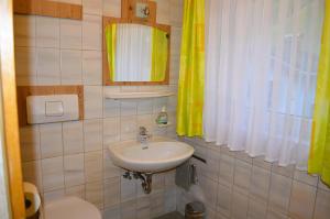 a bathroom with a sink and a toilet at Ferienwohnung Rohrmoser mit 1 Schlafzimmer in Hüttschlag +23 photos