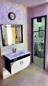 a bathroom with a sink and a toilet and a mirror at La Brise Saidia in Saïdia +20 photos