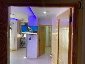 a hallway with a room with a tv on the wall at La Brise Saidia in Saïdia