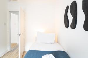 a bedroom with a bed and black shoes on the wall at Contractor Accommodation Avonmouth 3 Bedroom House Sleeps 6 Free Van Parking in Avonmouth