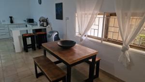 a table with a bowl on it in a kitchen at Spacious, secure, self contained apartment in Freetown