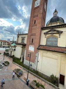 a building with a clock tower on top of it at Evelina Malpensa & Busto centro in Busto Arsizio +3 photos