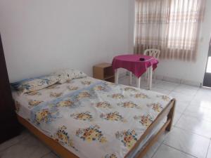 a bedroom with a bed with a table in it at Hospedaje Marvento in Pucallpa