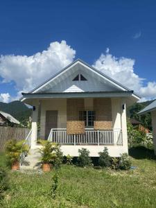 a small white house with a porch in a yard at Pai Fields Good in Pai +12 photos