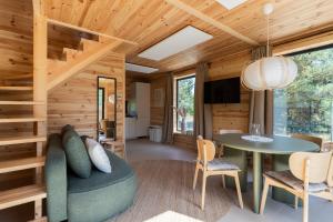 a living room with a couch and a table at Polna Osada Nadkole in Nadkole