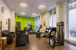 a gym with treadmills and exercise equipment in a room at Garner Hotel Bochum by IHG in Bochum