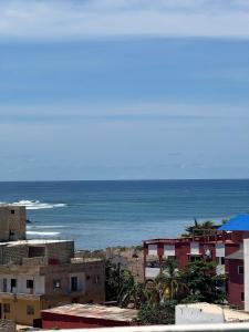 a view of the ocean from a city with buildings at BBimmo APPART HOTEL in Dakar
