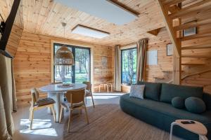 a living room with a couch and a table at Polna Osada Nadkole in Nadkole