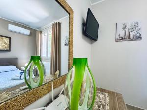 a bedroom with a large mirror and a bed at La Cinisara in Carini