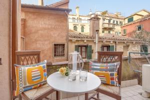 a white table and chairs on a balcony at Grimaldi Apartments Cannaregio in Venice