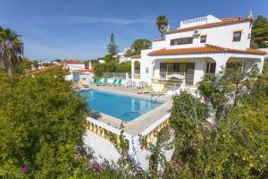 an image of a house with a swimming pool at Villa Curva do Monte by Villa Plus in Carvoeiro