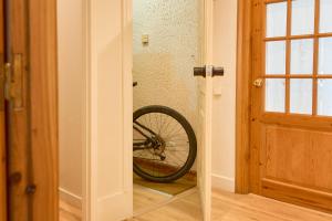 a bike sitting on the floor next to a door at Hotel Anglada in Vielha