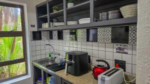 eine Küchentheke mit Spüle und Mikrowelle in der Unterkunft San Lameer Villa 2200 by Top Destinations Rentals in Southbroom + 15 Fotos